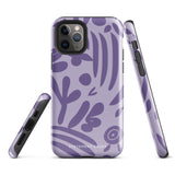 The Luna Morada for iPhone by Statement Cases is a durable phone case with a purple protective exterior featuring abstract dark purple and lavender patterns. The design includes geometric shapes and curves, giving it a modern artistic look. Made from impact-resistant polycarbonate, the lower part of the case prominently displays "STATEMENT CASES.