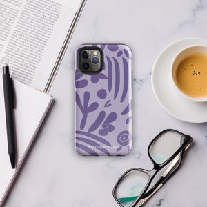 The Luna Morada for iPhone by Statement Cases is a durable phone case with a purple protective exterior featuring abstract dark purple and lavender patterns. The design includes geometric shapes and curves, giving it a modern artistic look. Made from impact-resistant polycarbonate, the lower part of the case prominently displays "STATEMENT CASES.