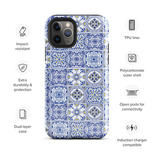 The Lisboa Azul for iPhone by Statement Cases is a smartphone adorned with a dual-layer protection phone case, featuring an intricate blue and white tile pattern. The design showcases various geometric and floral motifs, forming a visually appealing mosaic effect. The impact-resistant camera lenses and flash are prominently visible at the top left.