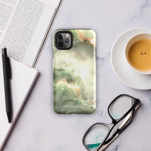 A Sleek Sage for iPhone with a marble-patterned case in shades of green, white, and gold. The protective case is branded with "Statement Cases" written at the bottom. Compatible with the iPhone 15 Pro Max, the phone's camera lens is prominent in the upper left corner.