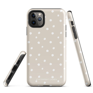 A beige Classic Nude for iPhone case with white polka dots, designed for the iPhone 15 Pro Max, covering the back of a phone with three visible camera lenses and one flash positioned at the upper left corner. This protective iPhone case features "Statement Cases" in small capital letters at the bottom.