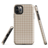 A smartphone with a brown and beige houndstooth-patterned case is shown from the back. The impact-resistant, dual-layered Classic Houndstooth for iPhone by Statement Cases protects the phone's body and leaves openings for the camera lenses and flash. The hues give the case a stylish and sophisticated appearance.