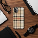 A Neutral Heritage Tartan for iPhone by Statement Cases with a plaid-patterned, impact-resistant polycarbonate case featuring beige, black, white, and red stripes. The durable phone case has the text "STATEMENT CASES" written at the bottom. The phone boasts a triple camera setup with an additional sensor and flash.