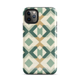 A Smartphone with a durable Old World Mosaic for iPhone case by Statement Cases showcasing a geometric pattern in shades of green, beige, and white. The symmetrical, angular designs create an almost star-like appearance. The impact-resistant polycarbonate construction ensures protection while the camera lenses remain visible at the top left corner.