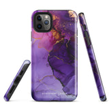 A Statement Cases Golden Orchid Marble for iPhone with a case featuring an abstract design of swirling purple, pink, and gold hues over a white background. The marbled patterns with metallic accents provide dual-layer protection and are impact-resistant. The top of the case has cutouts for the phone's camera lenses and is induction charging compatible.