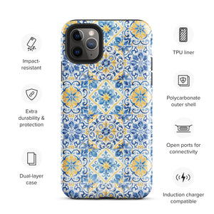 The Blue Mirage for iPhone by Statement Cases features a dual-layered, impact-resistant polycarbonate exterior with a TPU inner liner. Inspired by traditional Portuguese tiles, the blue and yellow patterned case boasts an intricate design of floral and geometric motifs. With its elegant and colorful appearance, the phone's camera is visible at the top left of the case.