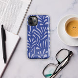 An iPhone encased in the "Mariposa Azul" by Statement Cases, featuring a blue design with an abstract white leaf pattern. The case combines curved and pointed shapes and provides dual-layer protection with TPU lining and impact-resistant polycarbonate. Camera lenses and other top elements remain unobstructed, and "Statement Cases" is inscribed at the bottom.