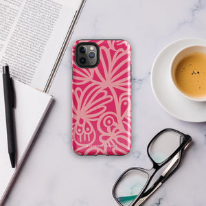 Introducing the Zafiro Rosa for iPhone by Statement Cases: a smartphone case featuring abstract floral and leaf patterns in various shades of pink. This dual-layer protection case combines an impact-resistant polycarbonate exterior with a TPU inner liner to ensure durability. The design showcases the brand name "Statement Cases" at the bottom, with precise cutouts revealing the phone’s camera lenses at the top left corner.