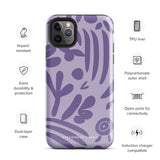 The Luna Morada for iPhone by Statement Cases is a durable phone case with a purple protective exterior featuring abstract dark purple and lavender patterns. The design includes geometric shapes and curves, giving it a modern artistic look. Made from impact-resistant polycarbonate, the lower part of the case prominently displays "STATEMENT CASES.