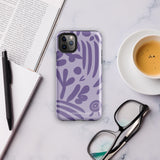 The Luna Morada for iPhone by Statement Cases is a durable phone case with a purple protective exterior featuring abstract dark purple and lavender patterns. The design includes geometric shapes and curves, giving it a modern artistic look. Made from impact-resistant polycarbonate, the lower part of the case prominently displays "STATEMENT CASES.