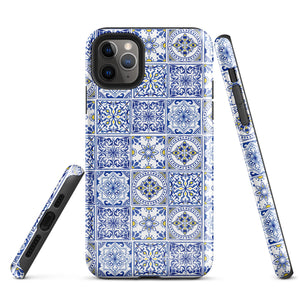 The Lisboa Azul for iPhone by Statement Cases is a smartphone adorned with a dual-layer protection phone case, featuring an intricate blue and white tile pattern. The design showcases various geometric and floral motifs, forming a visually appealing mosaic effect. The impact-resistant camera lenses and flash are prominently visible at the top left.