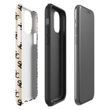 A beige protective iPhone case with an interlocking black "SC" pattern displayed across its back. Custom-tailored for the iPhone 15 Pro Max, the Heritage Monogram for iPhone by Statement Cases features cutouts for the camera lenses and buttons. The design is sleek and minimalistic.