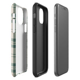 A smartphone with a beige and green plaid-patterned, impact-resistant polycarbonate case is shown. The phone’s rear camera lenses are prominently visible at the top left. The durable phone case features the words “Statement Cases” printed in small text at the bottom center. This is the Elegant Plaid for iPhone.