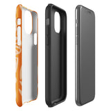 A Savannah Ardiente for iPhone from Statement Cases, featuring a dual-layered phone case in orange with a floral pattern showcasing cream-colored flowers, leaves, and geometric shapes. This impact-resistant polycarbonate case displays "STATEMENT CASES" at the bottom and reveals the camera lenses at the top left corner.