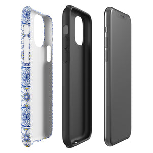 The Lisboa Azul for iPhone by Statement Cases is a smartphone adorned with a dual-layer protection phone case, featuring an intricate blue and white tile pattern. The design showcases various geometric and floral motifs, forming a visually appealing mosaic effect. The impact-resistant camera lenses and flash are prominently visible at the top left.