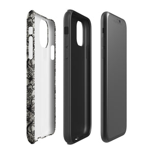 A protective *Omerta Floral for iPhone* case for the iPhone 15 Pro Max, featuring a black cover with an intricate floral lace design. The branding "Statement Cases" is visible at the bottom center, while the phone's camera lenses and flash are prominent at the top left of the case.