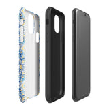 The Blue Mirage for iPhone by Statement Cases features a dual-layered, impact-resistant polycarbonate exterior with a TPU inner liner. Inspired by traditional Portuguese tiles, the blue and yellow patterned case boasts an intricate design of floral and geometric motifs. With its elegant and colorful appearance, the phone's camera is visible at the top left of the case.