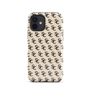 A beige protective iPhone case with an interlocking black "SC" pattern displayed across its back. Custom-tailored for the iPhone 15 Pro Max, the Heritage Monogram for iPhone by Statement Cases features cutouts for the camera lenses and buttons. The design is sleek and minimalistic.