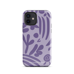 The Luna Morada for iPhone by Statement Cases is a durable phone case with a purple protective exterior featuring abstract dark purple and lavender patterns. The design includes geometric shapes and curves, giving it a modern artistic look. Made from impact-resistant polycarbonate, the lower part of the case prominently displays "STATEMENT CASES.