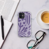 The Luna Morada for iPhone by Statement Cases is a durable phone case with a purple protective exterior featuring abstract dark purple and lavender patterns. The design includes geometric shapes and curves, giving it a modern artistic look. Made from impact-resistant polycarbonate, the lower part of the case prominently displays "STATEMENT CASES.