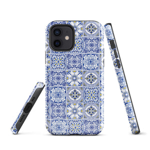 The Lisboa Azul for iPhone by Statement Cases is a smartphone adorned with a dual-layer protection phone case, featuring an intricate blue and white tile pattern. The design showcases various geometric and floral motifs, forming a visually appealing mosaic effect. The impact-resistant camera lenses and flash are prominently visible at the top left.