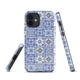 The Lisboa Azul for iPhone by Statement Cases is a smartphone adorned with a dual-layer protection phone case, featuring an intricate blue and white tile pattern. The design showcases various geometric and floral motifs, forming a visually appealing mosaic effect. The impact-resistant camera lenses and flash are prominently visible at the top left.