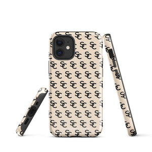 A beige protective iPhone case with an interlocking black "SC" pattern displayed across its back. Custom-tailored for the iPhone 15 Pro Max, the Heritage Monogram for iPhone by Statement Cases features cutouts for the camera lenses and buttons. The design is sleek and minimalistic.