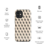 A beige protective iPhone case with an interlocking black "SC" pattern displayed across its back. Custom-tailored for the iPhone 15 Pro Max, the Heritage Monogram for iPhone by Statement Cases features cutouts for the camera lenses and buttons. The design is sleek and minimalistic.