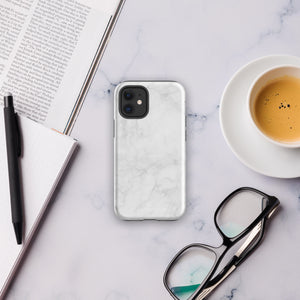 A protective iPhone case with a white marble-patterned design featuring three camera lenses and a flash. The marble pattern on this Marble Dreams for iPhone 15 Pro Max case is subtle, with light gray veining. The brand "Statement Cases" is subtly engraved at the bottom of the case.