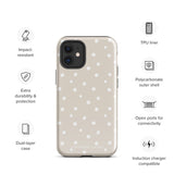 A beige Classic Nude for iPhone case with white polka dots, designed for the iPhone 15 Pro Max, covering the back of a phone with three visible camera lenses and one flash positioned at the upper left corner. This protective iPhone case features "Statement Cases" in small capital letters at the bottom.