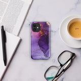 A Statement Cases Golden Orchid Marble for iPhone with a case featuring an abstract design of swirling purple, pink, and gold hues over a white background. The marbled patterns with metallic accents provide dual-layer protection and are impact-resistant. The top of the case has cutouts for the phone's camera lenses and is induction charging compatible.