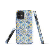 The Blue Mirage for iPhone by Statement Cases features a dual-layered, impact-resistant polycarbonate exterior with a TPU inner liner. Inspired by traditional Portuguese tiles, the blue and yellow patterned case boasts an intricate design of floral and geometric motifs. With its elegant and colorful appearance, the phone's camera is visible at the top left of the case.