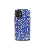 An iPhone encased in the "Mariposa Azul" by Statement Cases, featuring a blue design with an abstract white leaf pattern. The case combines curved and pointed shapes and provides dual-layer protection with TPU lining and impact-resistant polycarbonate. Camera lenses and other top elements remain unobstructed, and "Statement Cases" is inscribed at the bottom.