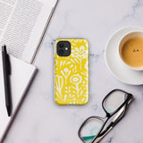 The Sol Dorado for iPhone by Statement Cases is a smartphone with a yellow case featuring a white, abstract floral and plant pattern. The camera lenses are prominent in the top left corner of the device. With dual-layer protection and impact-resistant TPU lining, "Statement Cases" is printed at the bottom of the case.