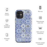 The Lisboa Azul for iPhone by Statement Cases is a smartphone adorned with a dual-layer protection phone case, featuring an intricate blue and white tile pattern. The design showcases various geometric and floral motifs, forming a visually appealing mosaic effect. The impact-resistant camera lenses and flash are prominently visible at the top left.