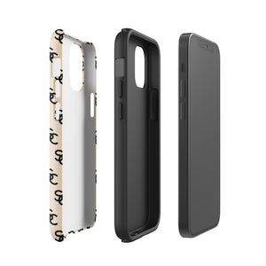 A beige protective iPhone case with an interlocking black "SC" pattern displayed across its back. Custom-tailored for the iPhone 15 Pro Max, the Heritage Monogram for iPhone by Statement Cases features cutouts for the camera lenses and buttons. The design is sleek and minimalistic.