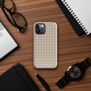 A smartphone with a brown and beige houndstooth-patterned case is shown from the back. The impact-resistant, dual-layered Classic Houndstooth for iPhone by Statement Cases protects the phone's body and leaves openings for the camera lenses and flash. The hues give the case a stylish and sophisticated appearance.