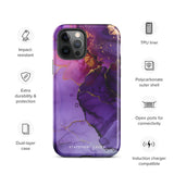 A Statement Cases Golden Orchid Marble for iPhone with a case featuring an abstract design of swirling purple, pink, and gold hues over a white background. The marbled patterns with metallic accents provide dual-layer protection and are impact-resistant. The top of the case has cutouts for the phone's camera lenses and is induction charging compatible.