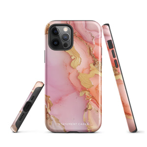 The Gold Blush Marble for iPhone showcases a glossy, marble-patterned case in shades of pink and gold. The decorative design features swirling patterns, seamlessly blending the colors. Crafted with impact-resistant polycarbonate for superior phone protection, "Statement Cases" is written in white at the bottom.