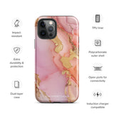 The Gold Blush Marble for iPhone showcases a glossy, marble-patterned case in shades of pink and gold. The decorative design features swirling patterns, seamlessly blending the colors. Crafted with impact-resistant polycarbonate for superior phone protection, "Statement Cases" is written in white at the bottom.