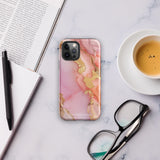 The Gold Blush Marble for iPhone showcases a glossy, marble-patterned case in shades of pink and gold. The decorative design features swirling patterns, seamlessly blending the colors. Crafted with impact-resistant polycarbonate for superior phone protection, "Statement Cases" is written in white at the bottom.