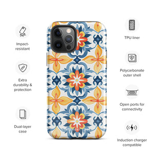 Statement Cases' Mediterranean Bloom for iPhone is showcased, featuring an intricate, colorful pattern. The design includes blue, yellow, and orange floral shapes in a symmetrical arrangement on a light blue background. This durable phone case provides dual-layer protection and is constructed from impact-resistant polycarbonate to safeguard your device.