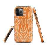 A Savannah Ardiente for iPhone from Statement Cases, featuring a dual-layered phone case in orange with a floral pattern showcasing cream-colored flowers, leaves, and geometric shapes. This impact-resistant polycarbonate case displays "STATEMENT CASES" at the bottom and reveals the camera lenses at the top left corner.