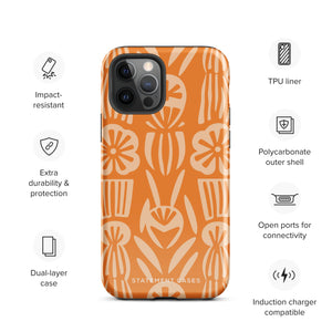 A Savannah Ardiente for iPhone from Statement Cases, featuring a dual-layered phone case in orange with a floral pattern showcasing cream-colored flowers, leaves, and geometric shapes. This impact-resistant polycarbonate case displays "STATEMENT CASES" at the bottom and reveals the camera lenses at the top left corner.