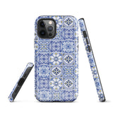 The Lisboa Azul for iPhone by Statement Cases is a smartphone adorned with a dual-layer protection phone case, featuring an intricate blue and white tile pattern. The design showcases various geometric and floral motifs, forming a visually appealing mosaic effect. The impact-resistant camera lenses and flash are prominently visible at the top left.