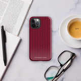 A protective iPhone case with a maroon background and a repeating pattern of small eyeglasses. Designed for the iPhone 15 Pro Max, the camera and buttons of the phone are visible. The bottom of the case features the text "Rockstar Red for iPhone" in white from Statement Cases.