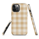 A Gingham Grace for iPhone by Statement Cases is covered with a protective case featuring a beige and white checkered pattern. The case's design includes a matte finish, dual-layer protection with an impact-resistant polycarbonate exterior and TPU lining, and the text "Statement Cases" printed near the bottom. The phone's cameras and buttons are visible.