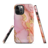 The Gold Blush Marble for iPhone showcases a glossy, marble-patterned case in shades of pink and gold. The decorative design features swirling patterns, seamlessly blending the colors. Crafted with impact-resistant polycarbonate for superior phone protection, "Statement Cases" is written in white at the bottom.