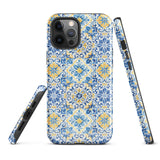 The Blue Mirage for iPhone by Statement Cases features a dual-layered, impact-resistant polycarbonate exterior with a TPU inner liner. Inspired by traditional Portuguese tiles, the blue and yellow patterned case boasts an intricate design of floral and geometric motifs. With its elegant and colorful appearance, the phone's camera is visible at the top left of the case.