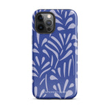 An iPhone encased in the "Mariposa Azul" by Statement Cases, featuring a blue design with an abstract white leaf pattern. The case combines curved and pointed shapes and provides dual-layer protection with TPU lining and impact-resistant polycarbonate. Camera lenses and other top elements remain unobstructed, and "Statement Cases" is inscribed at the bottom.